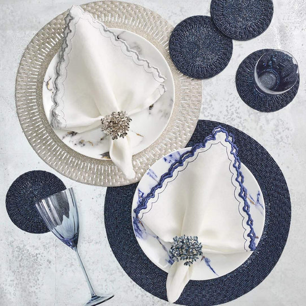Navy and silver table settings featuring Aster napkin rings in midnight blue and silver by Kim Seybert