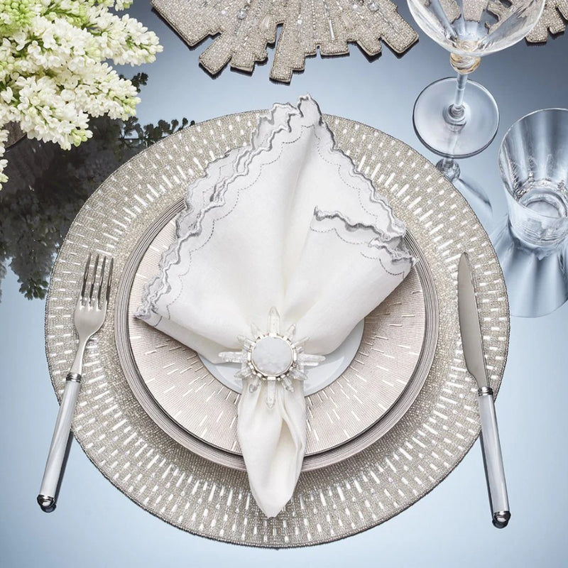 Overhead view of elegant table setting featuring Coronet napkin ring by Kim Seybert, sold at Amiramour