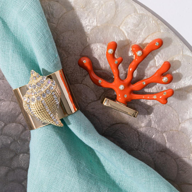 Close-up of Shell Napkin Ring on turquoise napkin surrounded by beach-inspired table elements
