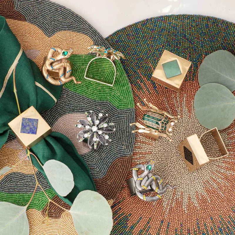 Green napkin with Deco Cube Napkin Ring by Joanna Buchanan, styled with matching pieces from the collection