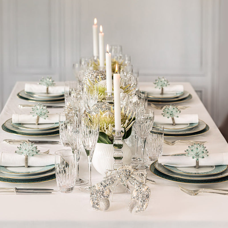 Full table view of luxury turquoise and white setting featuring Kim Seybert’s Constellation Napkin Rings