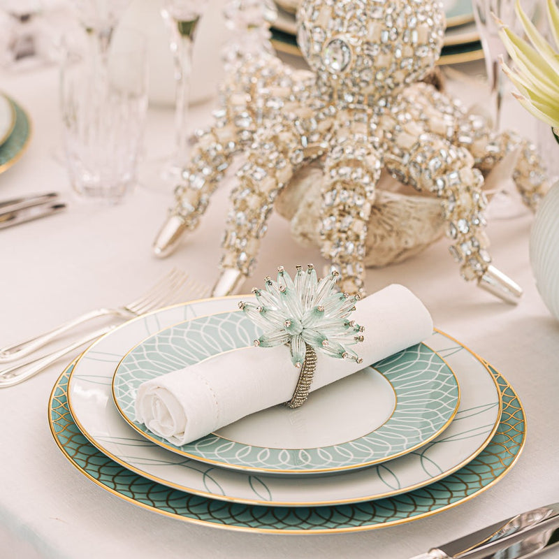 Elegant turquoise and white table arrangement with beaded napkin rings by Kim Seybert