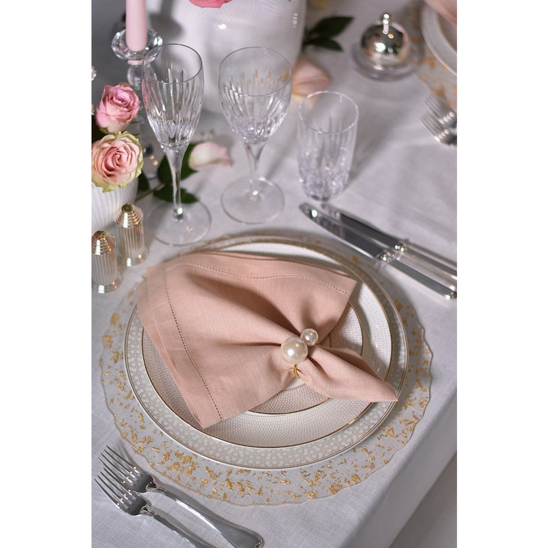 Elegant rose-toned table setting with ivory pearl napkin ring accents, sold by Amiramour