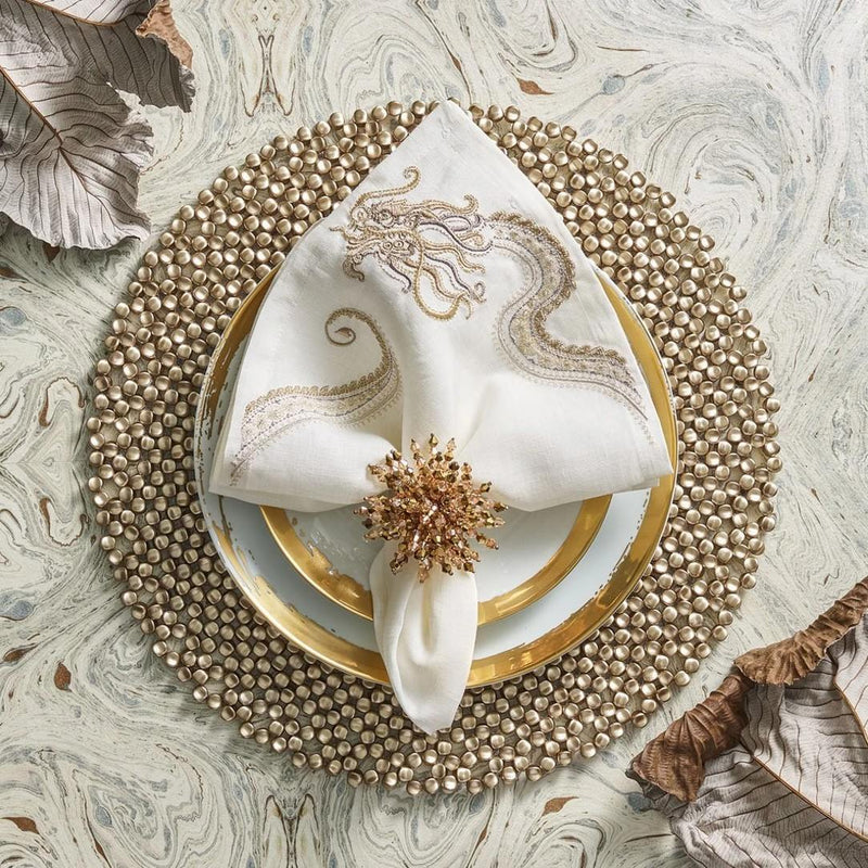 Elegant gold-toned table setting with Brilliant Napkin Ring by Kim Seybert