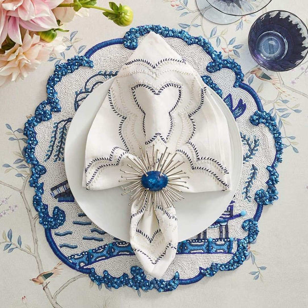 Elegant white and blue luxury table setting featuring Flare Napkin Ring by Kim Seybert