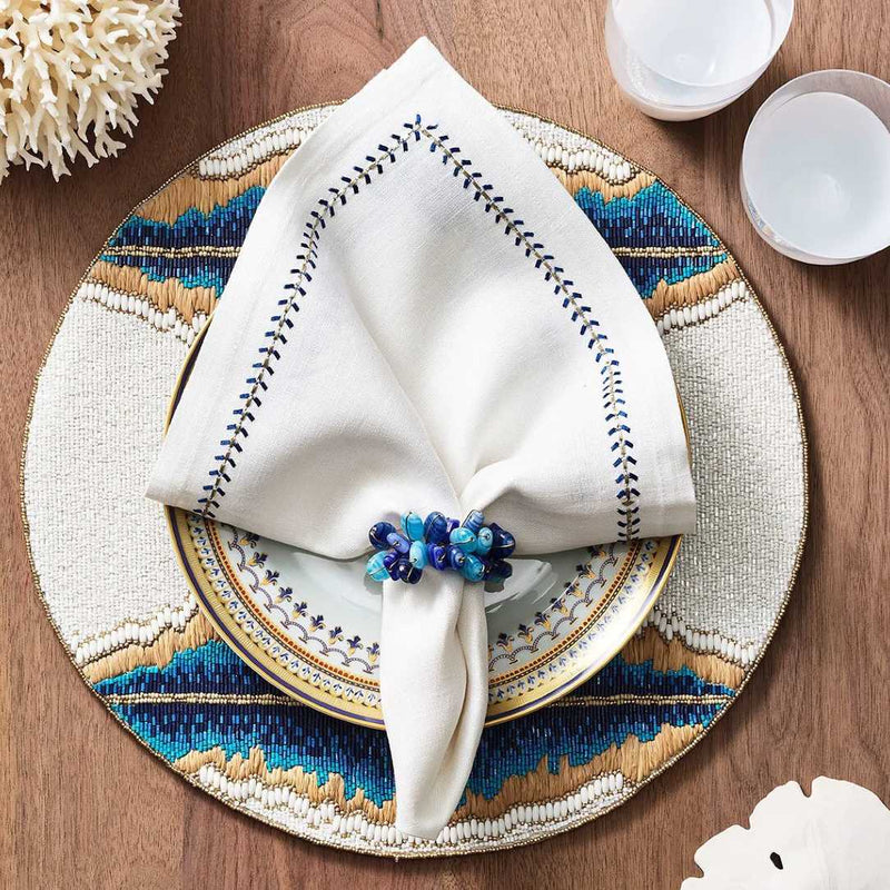 Beach-themed table arrangement in natural, white and blue featuring Poppy Napkin Rings