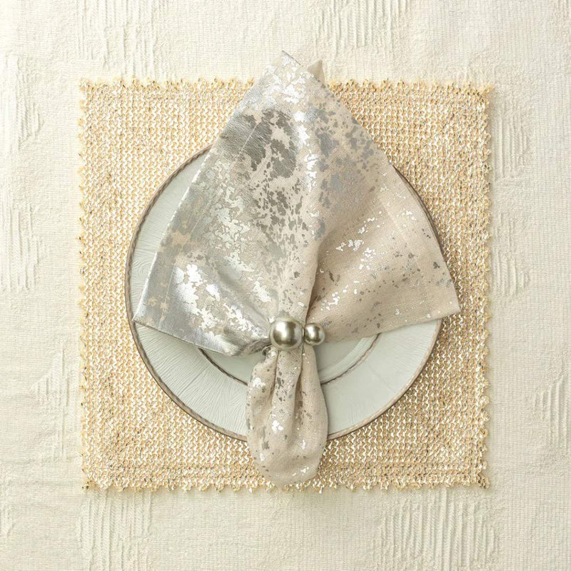 Pearl grey and silver Kim Seybert napkin ring paired with a luxurious gold placemat.
