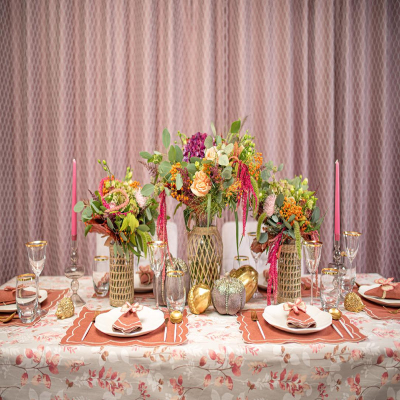 Full table setup featuring Pink Bows napkin rings by Roseberry Home with pink and brick-red tones