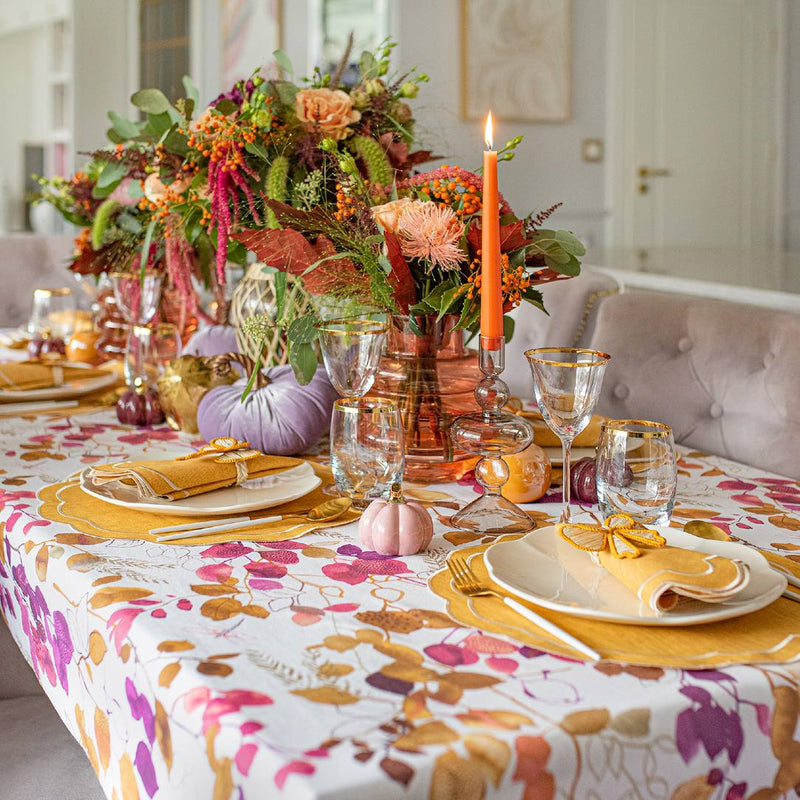 Colorful table setup featuring Yellow Bows napkin rings by Roseberry Home with orange, pink, purple, and white accents
