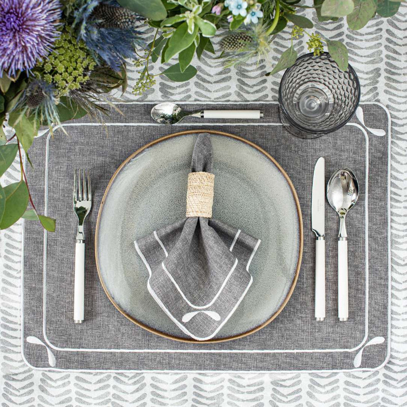 Overhead view of table setting with Beige Rings napkin rings in soft grey tones
