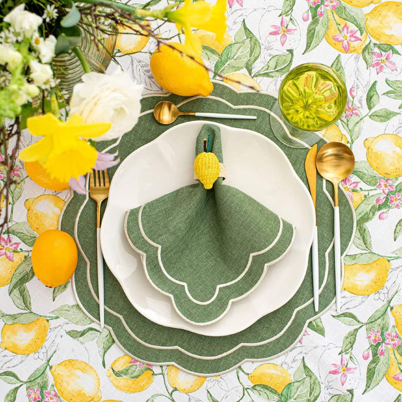 Overhead view of table setting in green, beige, and yellow featuring Lemon Rings napkin rings by Roseberry Home