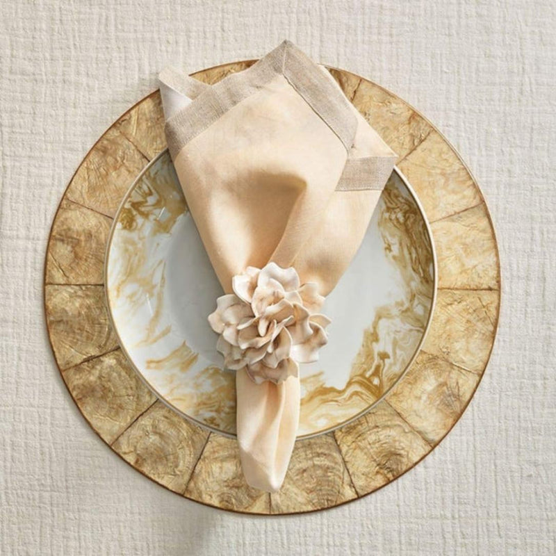 Champagne-gold capiz shell round placemat luxury tableware by Kim Seybert with floral napkin ring.