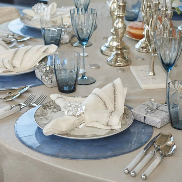 Periwinkle blue Capiz shell placemat by Kim Seybert on luxurious tablescape.