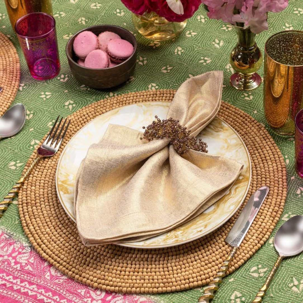Natural wood bead round placemat by Kim Seybert o casual refined tablescape.
