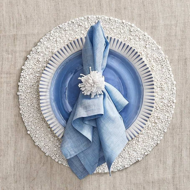 Coastal-inspired white beaded placemat for refined luxury dining.