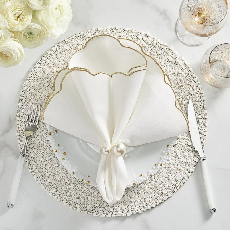 Elegant dining setup with white Bianco round beaded placemat.