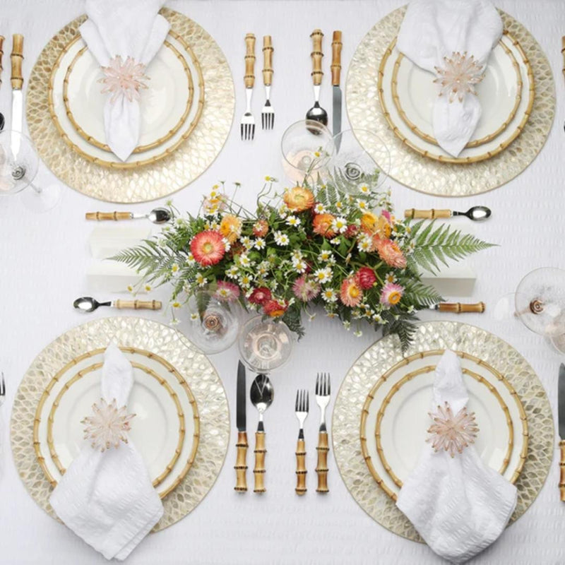 Champagne gold round placemat with hand-cut capiz shells by Kim Seybert on luxurious floral tablescape.