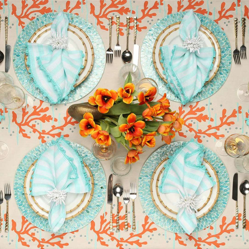 Seafoam blue placemat with radiant inlaid capiz shells on seaside luxe table setting.