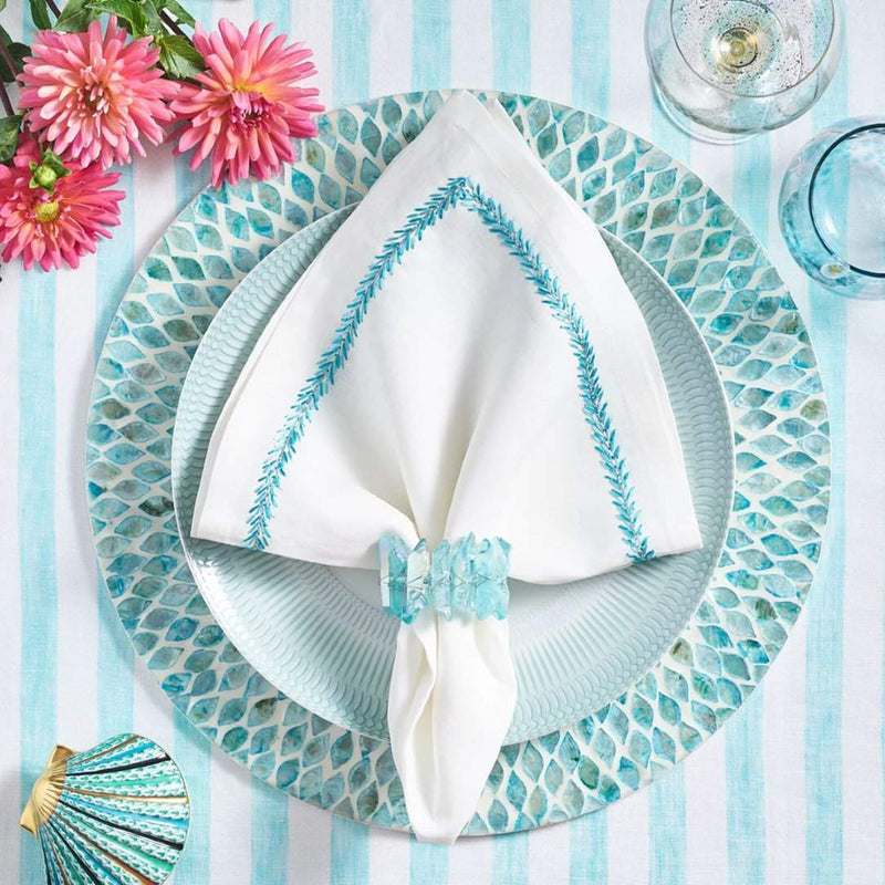 Seafoam blue placemat with radiant inlaid capiz shells with white napkin.