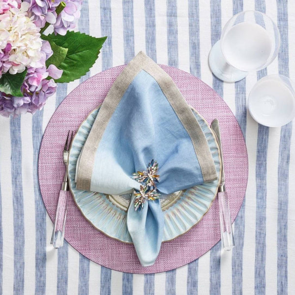 Lilac woven Portofino placemat with raffia-like texture by Kim Seybert with blue npkin.
