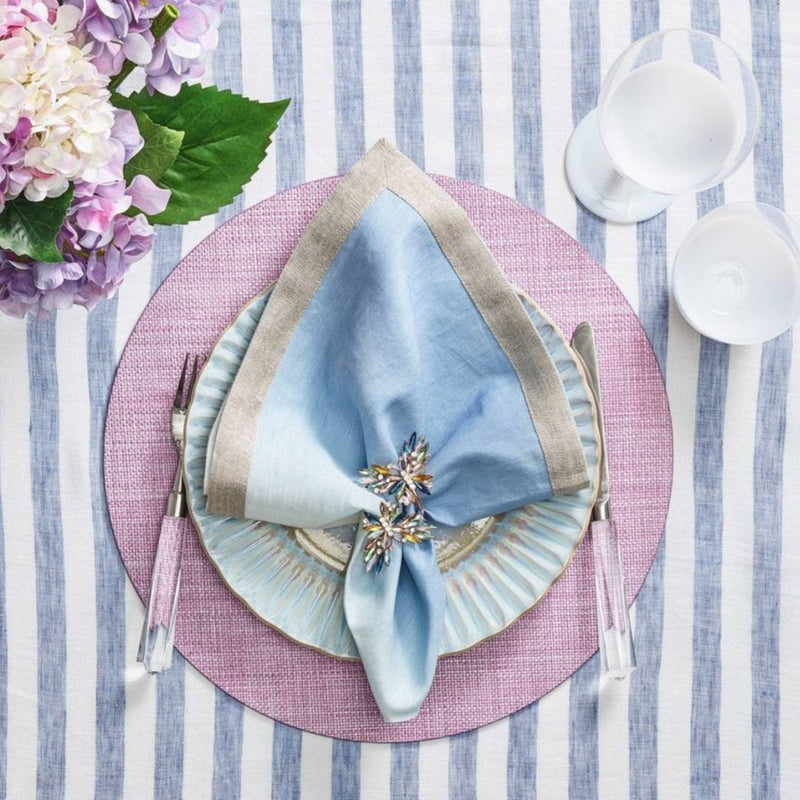 Lilac woven Portofino placemat with raffia-like texture by Kim Seybert with blue npkin.