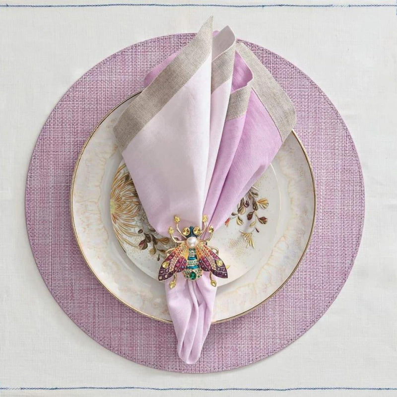 Lilac woven Portofino placemat with raffia-like texture by Kim Seybert with pink napkin.