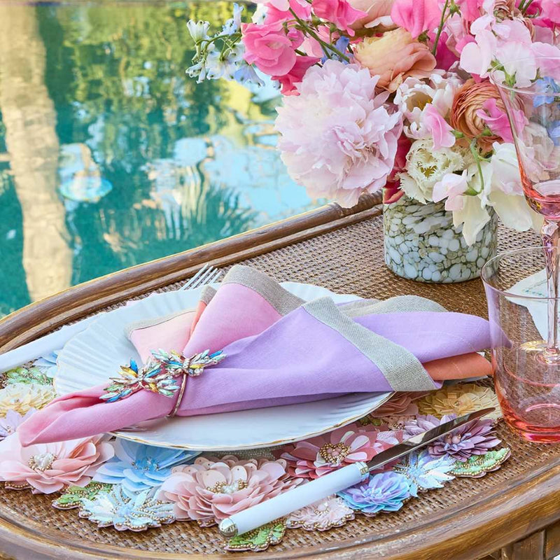Hand-beaded Dahlia placemat in pastel pink, blue, and yellow styled on luxury floral tabescape.