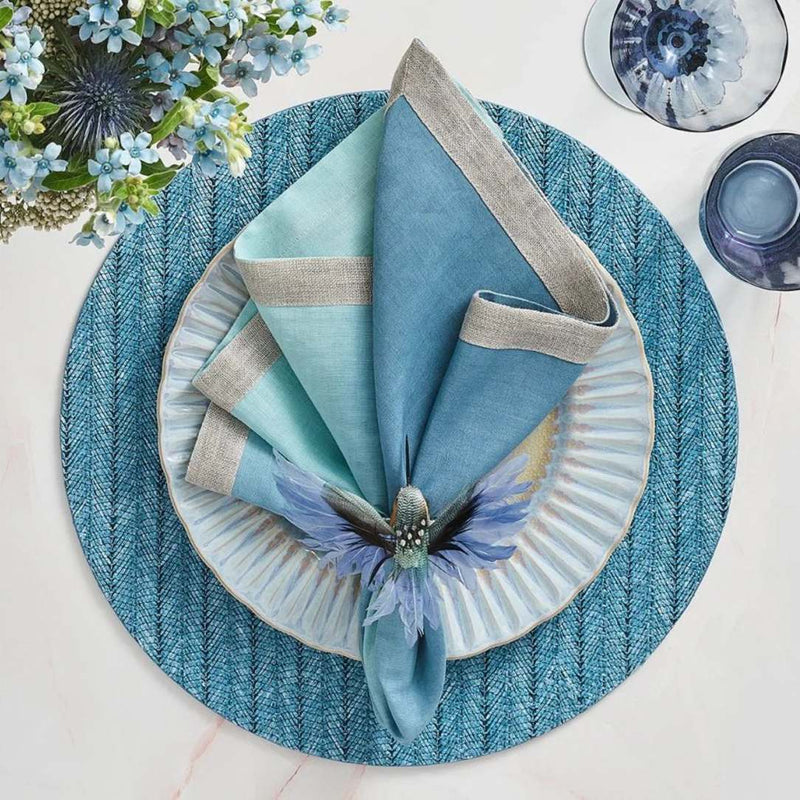 Indigo blue woven herringbone round placemat with blue bird napkin ring.