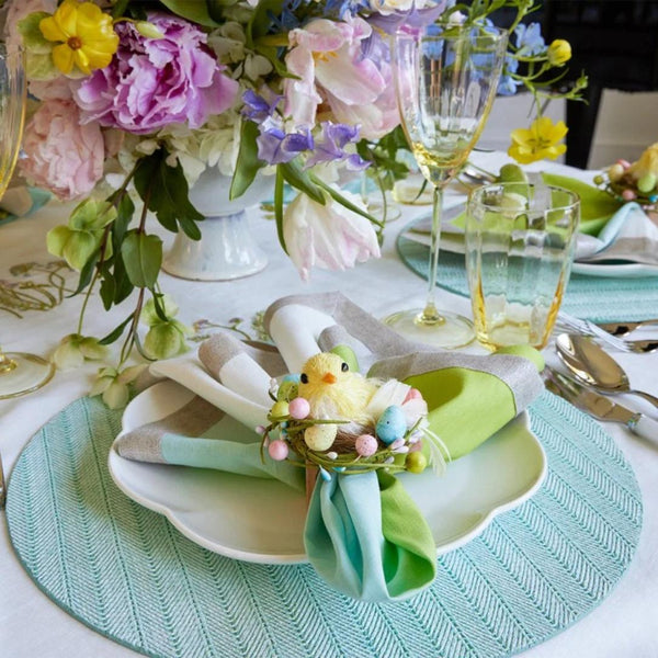 Seafoam green woven herringbone round placemat on spring Easter tablescape.