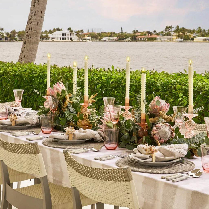 Luxury round placemat in gray with driftwood-inspired beads on coastal grey table setting.