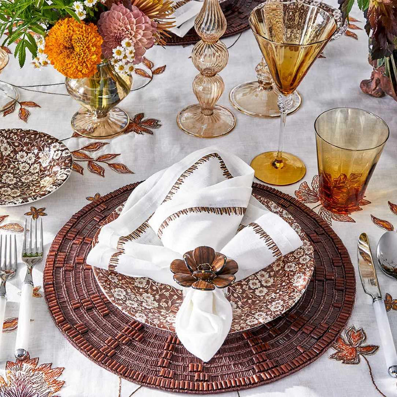 Wood Matrix placemat in brown by Kim Seybert styled with wood napkin ring.