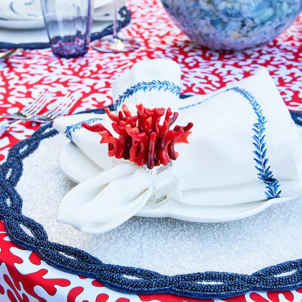 White and navy hand-beaded Infinity placemat with loop motif with coastal table decor.