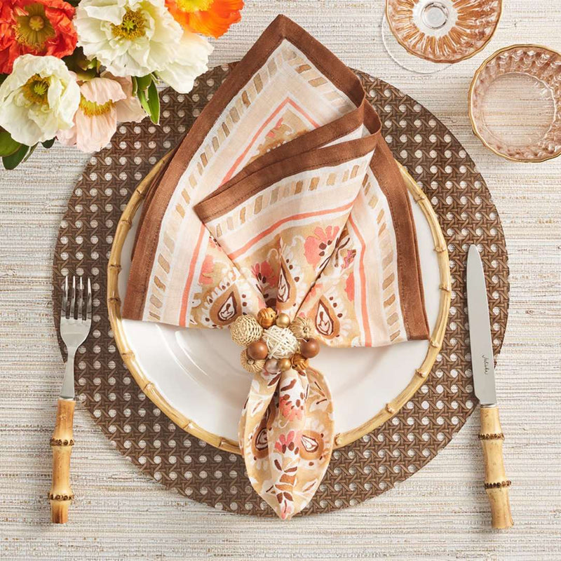 Reed placemat in brown faux wicker by Kim Seybert with brown napkin.