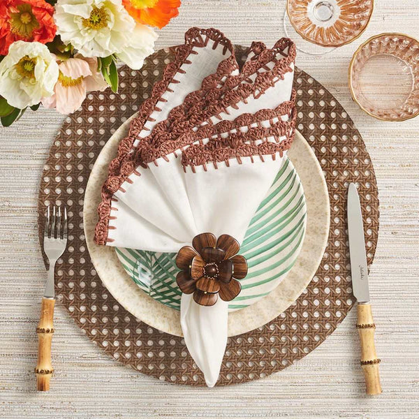 Reed placemat in brown faux wicker by Kim Seybert styled with brown ruffles napkin.