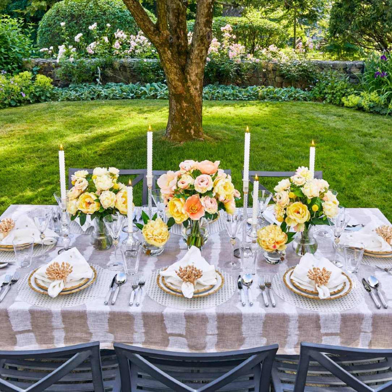 Amiramour Reed Placemat in White by Kim Seybert on outdoor tablescape.