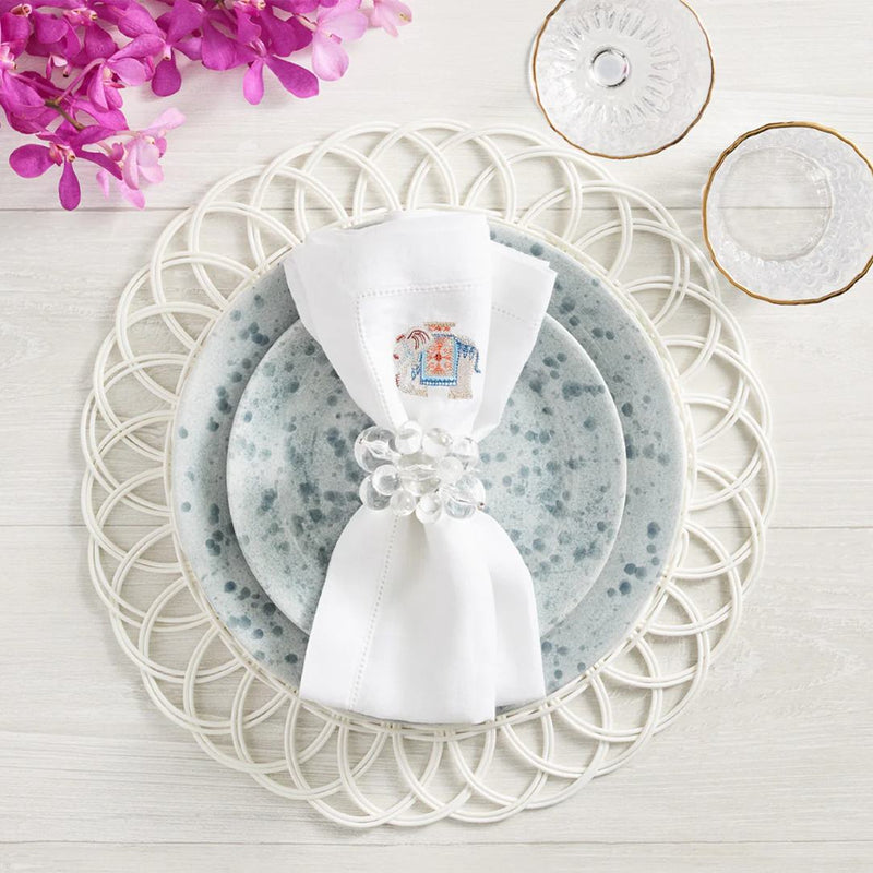 Luxury white faux rattan Alfresco placemat by Kim Seybert with clear napkin ring.