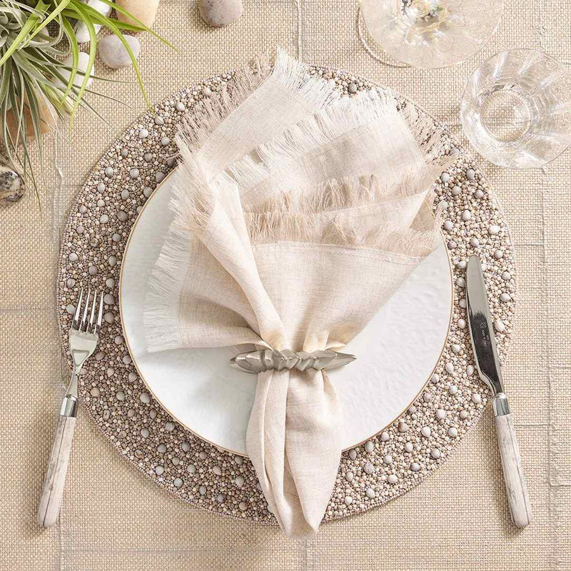 Gray and taupe Zen placemat with wood and glass bead detailing by Kim Seybert on modern table setting.