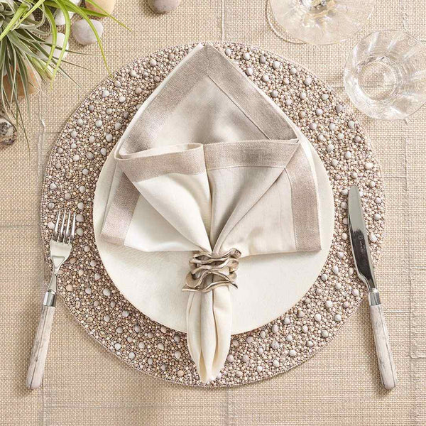 Gray and taupe Zen placemat with wood and glass bead detailing by Kim Seybert styled with silver accents.