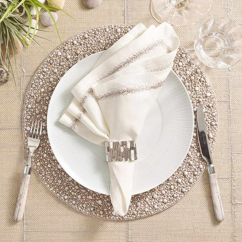 Gray and taupe Zen placemat with wood and glass bead detailing by Kim Seybert with white napkin.
