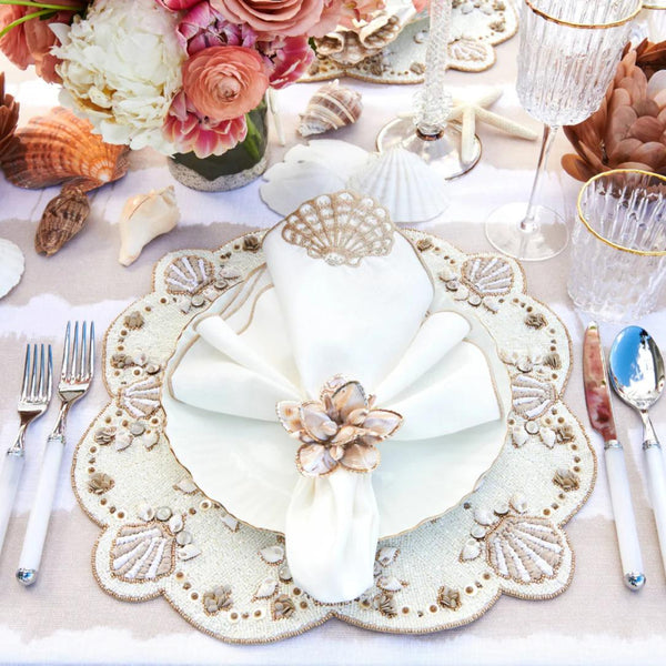 Beachcomber placemat with mother-of-pearl and gold shell accents top view.