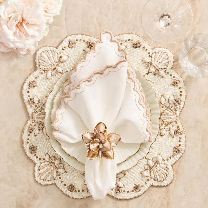 Beachcomber placemat with mother-of-pearl and gold shell accents with matching napkin ring.