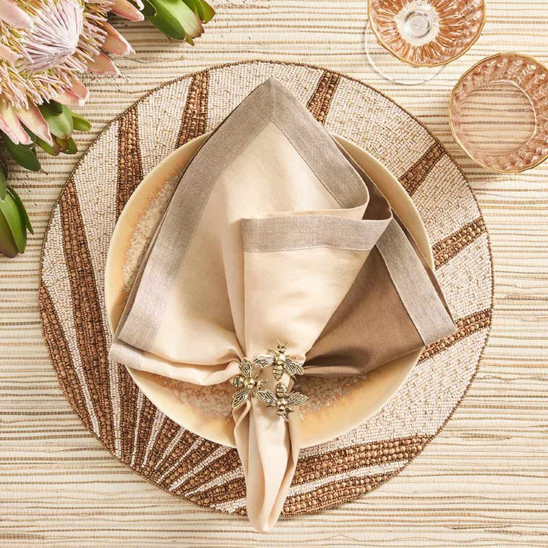 Luxury natural and brown placemat with tropical beaded details with brown luxe napkin.