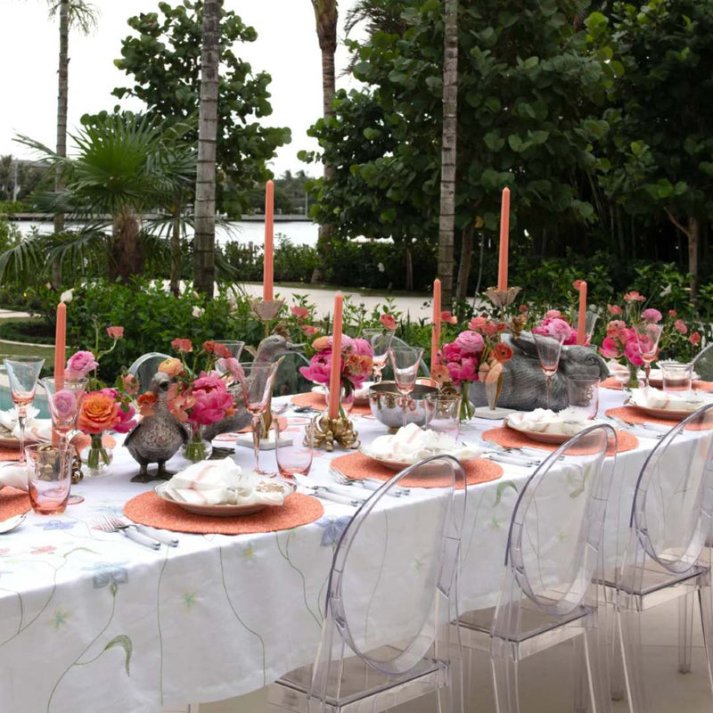 Coral Perennial placemat by Kim Seybert on outdoor tablescape.