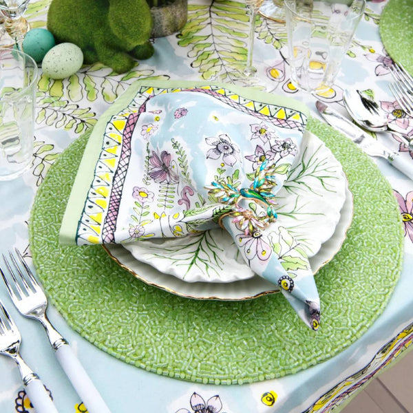 Green hand-beaded placemat with vermicelli pattern on Easter tablescape.