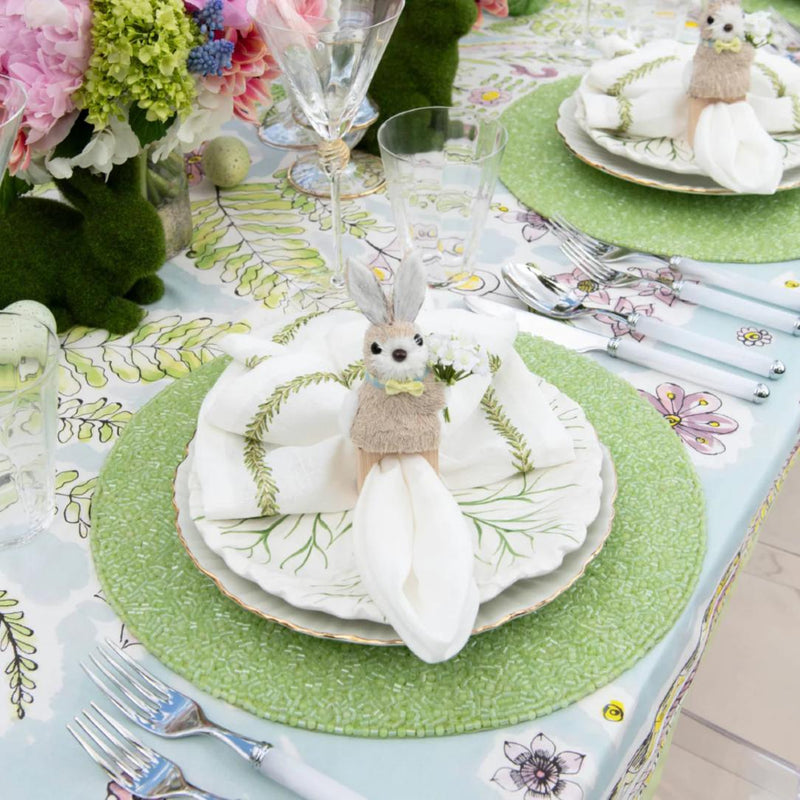 Green hand-beaded placemat with vermicelli pattern with bunny napkin ring.