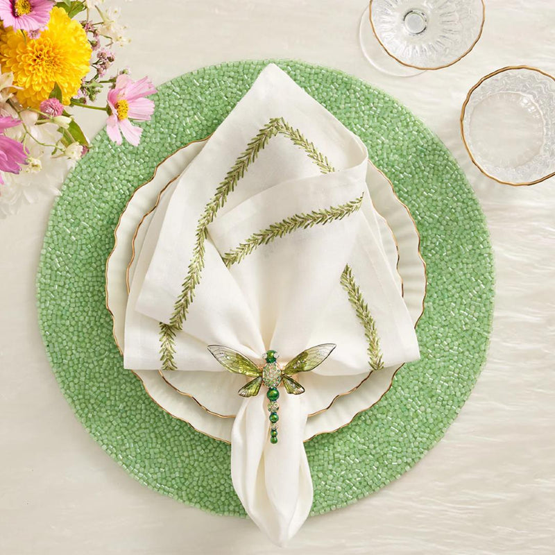 Green hand-beaded placemat with vermicelli pattern with dragonfly napkin ring.