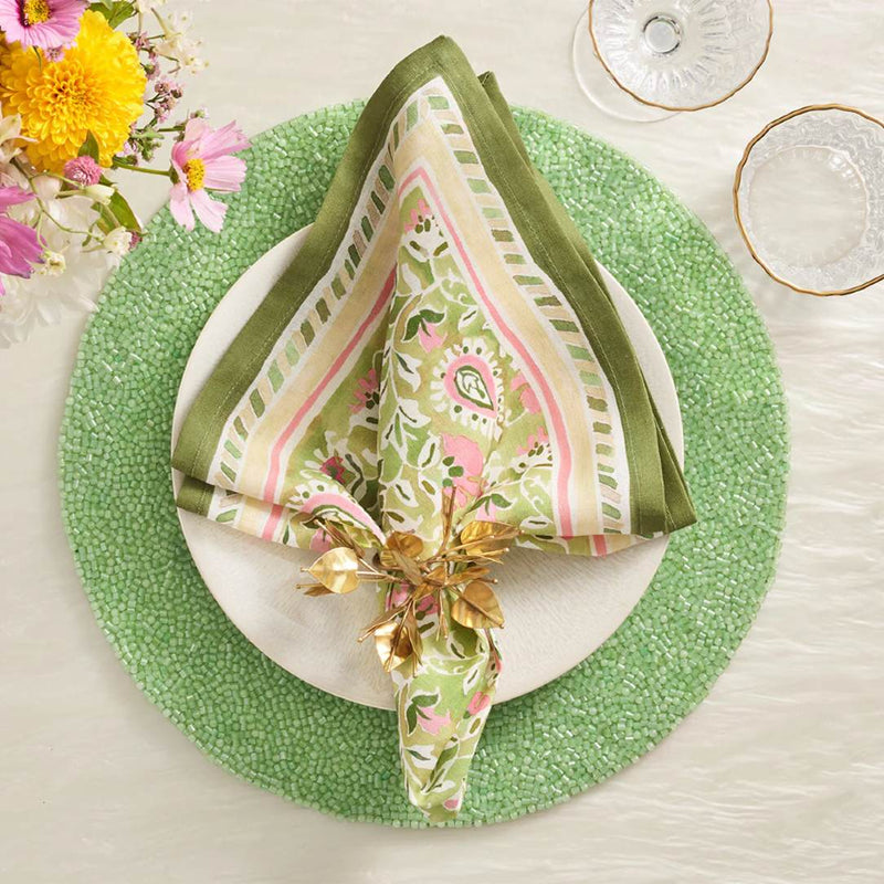 Green hand-beaded placemat with vermicelli pattern with green napkin.
