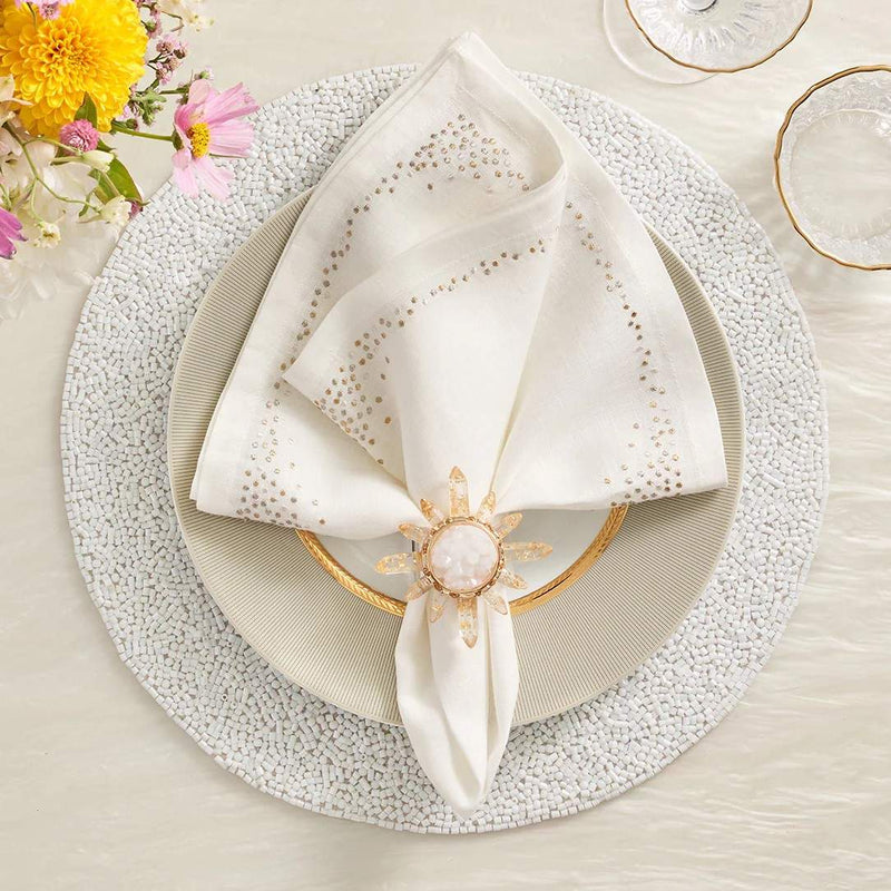 White beaded Perennial placemat with vermicelli pattern by Kim Seybert styled with white napkin.