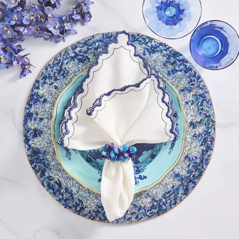 Lagoon Placemat hand-beaded in navy and blue tones with white napkin.