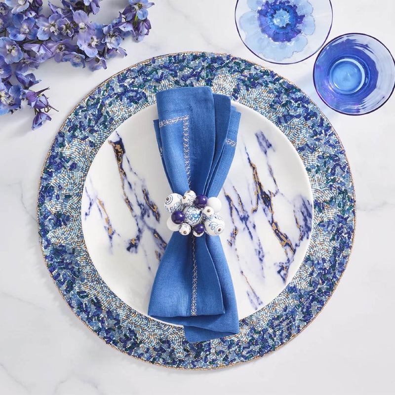 Lagoon Placemat hand-beaded in navy and blue tones with blue napkin.